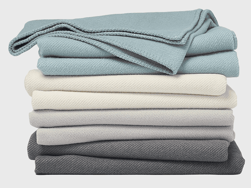 folded organic cotton blanket, assorted-color comforter set, certified organic bedding, chenille fabric linens, cozy bedroom textiles, soft duvet covers, premium home textiles